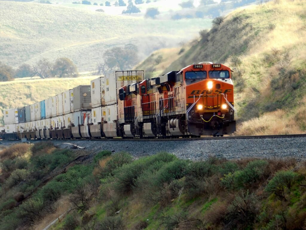 pexels-photo-30793053-30793053 Freight train passing through scenic hills with vibrant landscape.