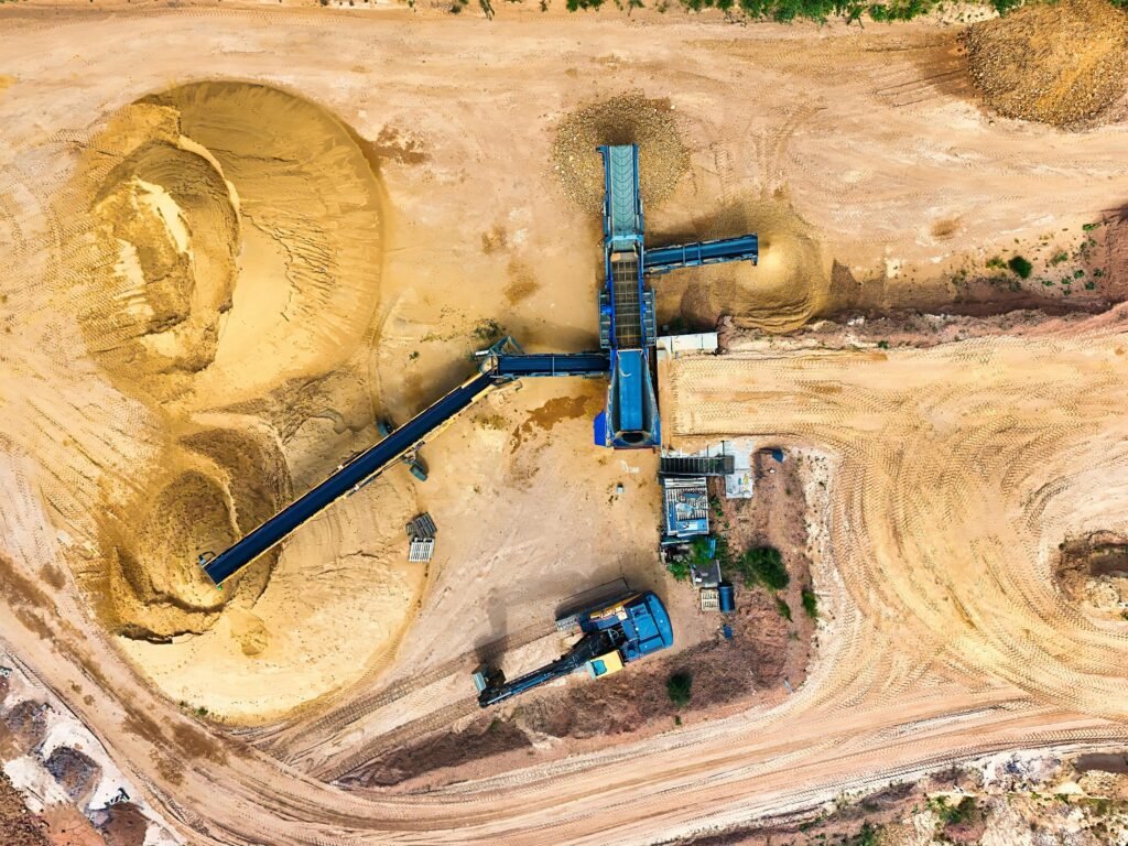 pexels-photo-33122152-33122152 Drone shot of a sand quarry with conveyor belts and machinery in operation.
