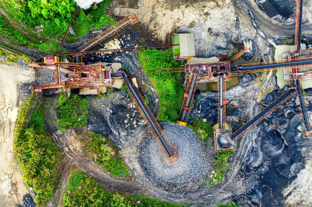 Drone view of a mining site in Rumpin, West Java with greenery and machinery.